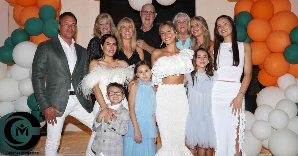 Alix Earle smiling with her parents, siblings, and extended family at a celebration event.
