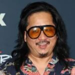 Bobby Lee smiling on the red carpet at an FX event wearing a floral shirt and oversized sunglasses.