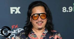 Bobby Lee smiling on the red carpet at an FX event wearing a floral shirt and oversized sunglasses.