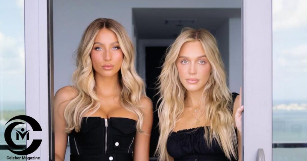 Alix Earle and Alex Cooper posing together in black outfits with blonde hair in a modern interior setting.